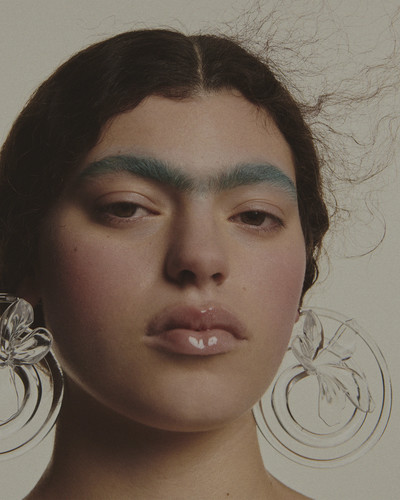 Isla wears earrings by Hugo Kreit. - © System Magazine