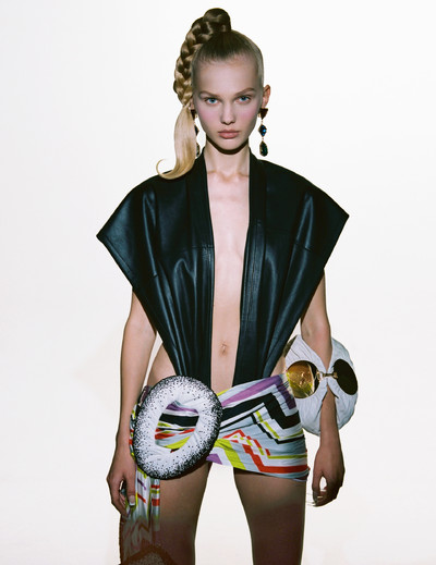 Vasilina wears trousers (as top), dress and bracelet bag by Loewe, and earrings by Saint Laurent. - © System Magazine