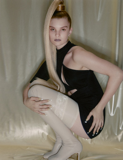 Ali wears dress and boots by Stella McCartney, earrings by Repossi, and stylist’s own stockings. - © System Magazine