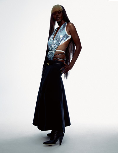 Aweng wears bodysuit by Rick Owens, skirt and belt by Dior, boots by Fendi, and stylist’s own panties. - © System Magazine
