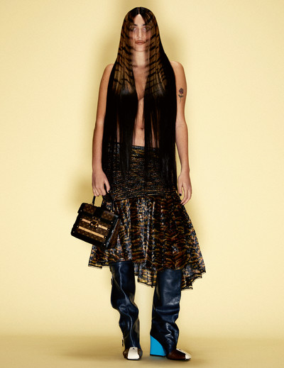 Valentine wears skirt, boots and bag by Louis Vuitton. - © System Magazine