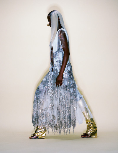 Precious wears dress by Alexander McQueen, rhinestone top by Gucci, necklace by Jil Sander, shoes by Mugler, and leg warmers by Haley Wollens Studio. - © System Magazine
