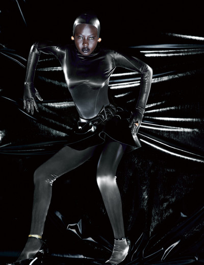 Aweng wears a jumpsuit, skirt, hood, ring, earrings and shoes by Mugler, and stylist’s own gold anklet. - © System Magazine