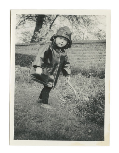 An immoderate aesthete. Hamish Bowles. - © Bowles, aged 2, in a mini-Mod black vinyl raincoat and matching fisherman&rsquo;s hat, Belsize Park., System Magazine