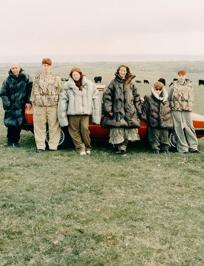 From left to right: Dean wears a puffer jacket by Moncler + Dingyun Zhang, black overalls by M.C.Overalls, and his own shoes. Shane wears a reversible puffer vest by Moncler + Dingyun Zhang, beige cotton overalls by The Contemporary Wardrobe, and his own shoes. Skye wears a cropped puffer jacket by Moncler + Dingyun Zhang, khaki cotton overalls by The Contemporary Wardrobe, and her own shoes. Tanya wears long puffer jacket and windbreaker by Moncler + Dingyun Zhang, overalls by The Arc, and her own shoes. Owin wears a reversible puffer vest by Moncler + Dingyun Zhang, khaki cotton overalls by The Arc, and his own shoes. Zack wears an reversible puffer vest by Moncler + Dingyun Zhang, khaki cotton overalls by The Arc, and his own shoes. - © System Magazine