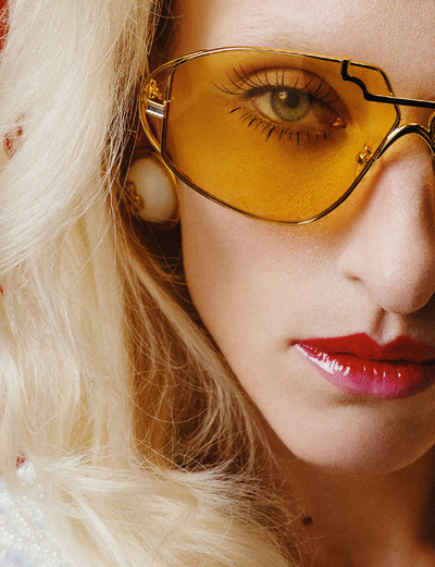 Maggie wears white and gold resin dome earrings, and yellow tinted 18k gold plated metal aviator frames, all by Casablanca. - © System Magazine