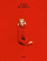 Maggie wears red and gold resin dome earrings, red tricot track top, red lapel wool tailored jacket, and Casablanca tennis club enamel ring, all by Casablanca. - © System Magazine