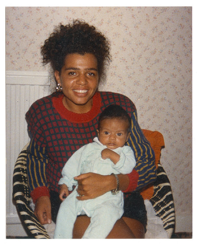 1988. ‘Michelle at her friend Karen’s house, posing with Karen’s baby, Sean. She was just back from holiday in Turkey and wearing her French Connection jumper.’ - © System Magazine