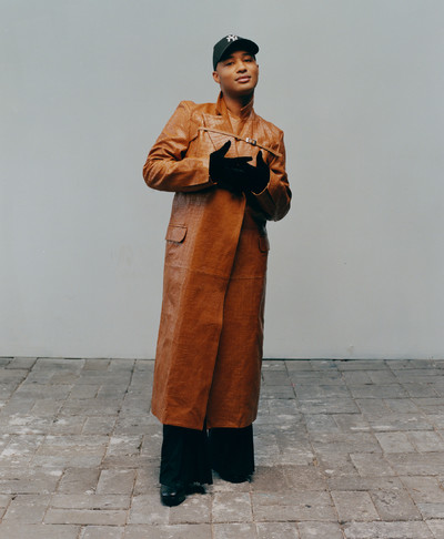 Brandon Blackwood, designer and friend of Raul Lopez, wears croc embossed cognac belted trench, hybrid tech trousers, and runway velvet gloves, all by Luar, and designer’s own hat and accessories. - © System Magazine
