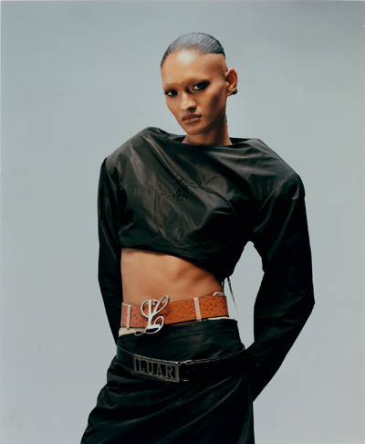 Sinn Apsara, model, wears boulder-shoulder pullover and runway nylon tube skirt, tan ostrich Ana belt, and Luar name belt, all by Luar. - © System Magazine