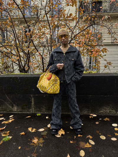 Pharrell. In Paris. - © Monogram fishnet denim hooded blouson, flared denim pants, Millionaire Speedy
P9 with LV crab keychain, and derby shoes., System Magazine