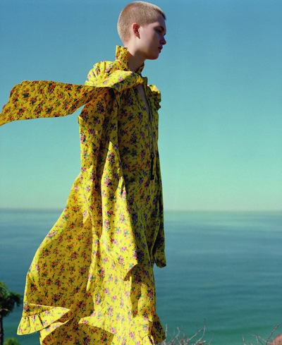 Yellow floral-print silk dress by Vetements
Black leather rocking-horse boots by Vivienne Westwood from Resurrection
White pearl-drop earring by Aurélie Bidermann - © System Magazine