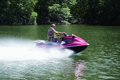 Jean Pigozzi wearing an XXXL bespoke printed silk Moschino lounge suit, made by Jeremy Scott for this story. ‘I am on my jet ski rushing to a meeting with the king of the monkeys in a mangrove in the north of Panama.’ - © System Magazine